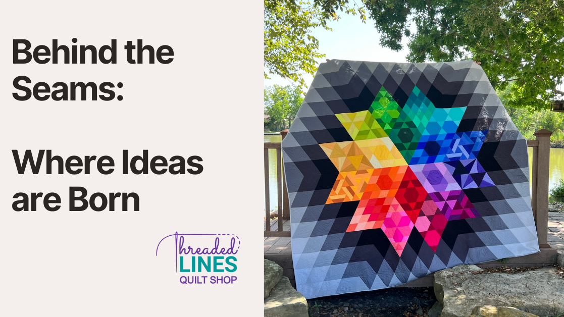 A rainbow star quilt against a natural setting with trees and a lake.